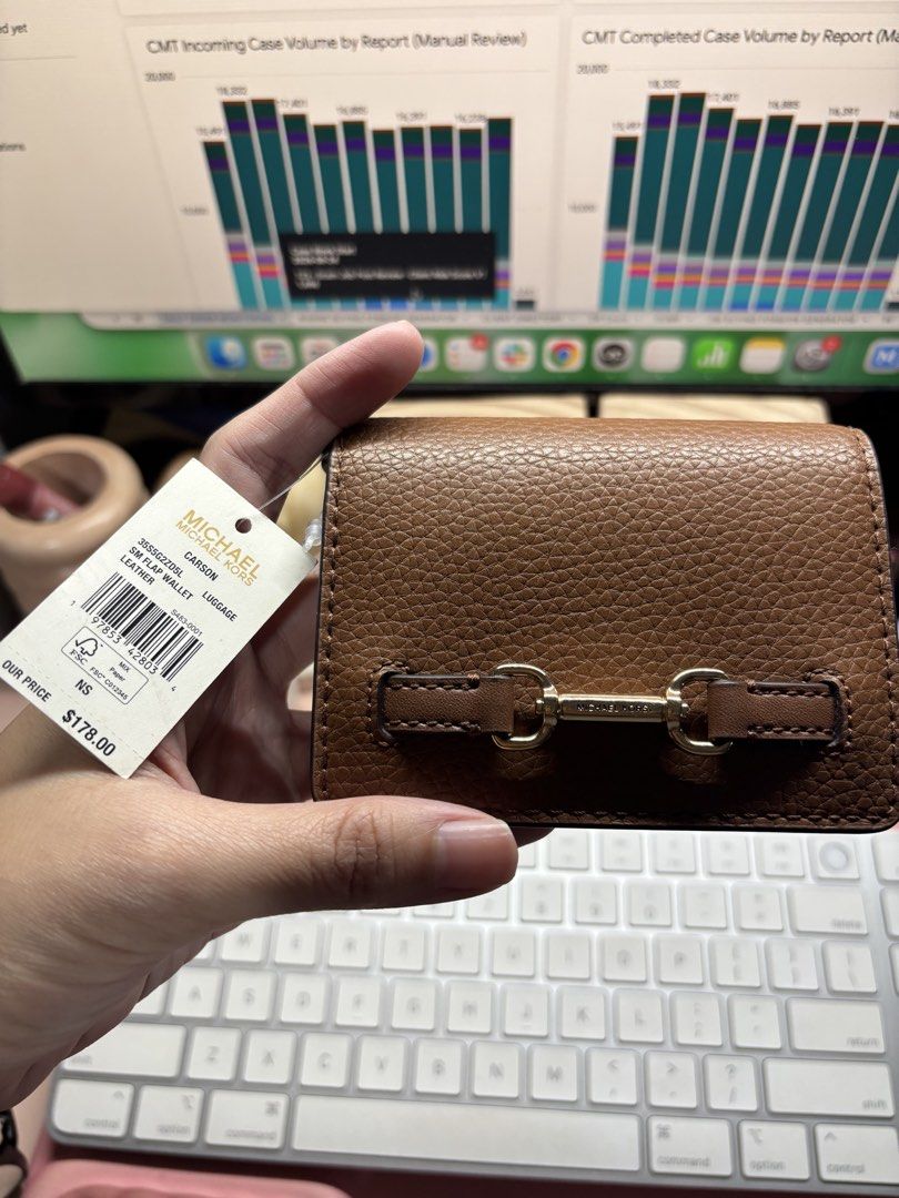 Michael Kors Carson Sm Flap Wallet (Category: Wallets & Card holders) located in San Juan City. Submitted by warmriver.74e50b (Listing ID 1464756133, Image 2). Description: - Brand: Michael Kors - Color: Luggage Brown - Material: Genuine pebbled leather - Retail Price: $178 (Original tag included) - Hardware: Gold-tone with MK lettering - Closure: Snap button - Interior: Card slots and zippered coin compartment - Condition: Brand new and 100% aut