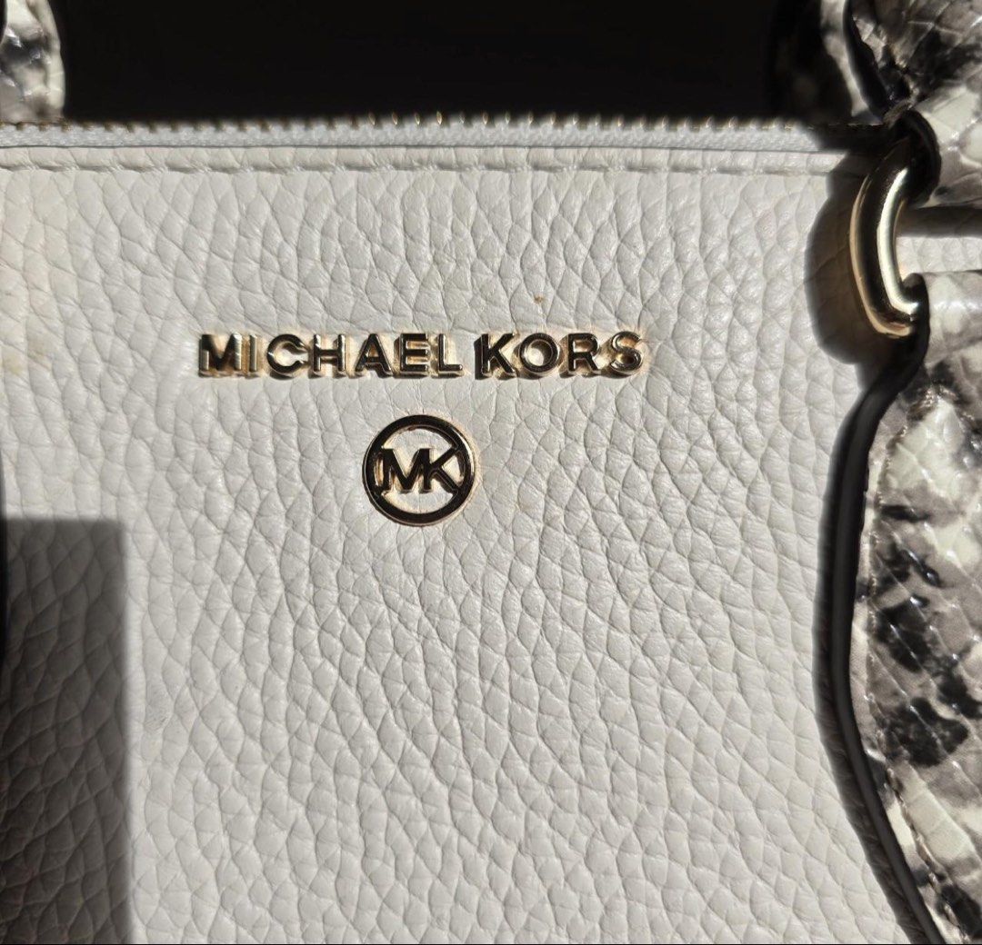 Michael Kors Cream Python Print Satchel Crossbody Bag (Category: Luxury Bags & Wallets) located in Manila. Submitted by kaia_studios (Listing ID 1464700991, Image 2). Description: Cream pebbled leather satchel with snakeskin-embossed handles and detachable crossbody strap. Gold-tone hardware and Michael Kors logo lettering on front. Zip top closure. Interior has custom fabric lining with multiple slip pockets and one zippered pocket with a leathe