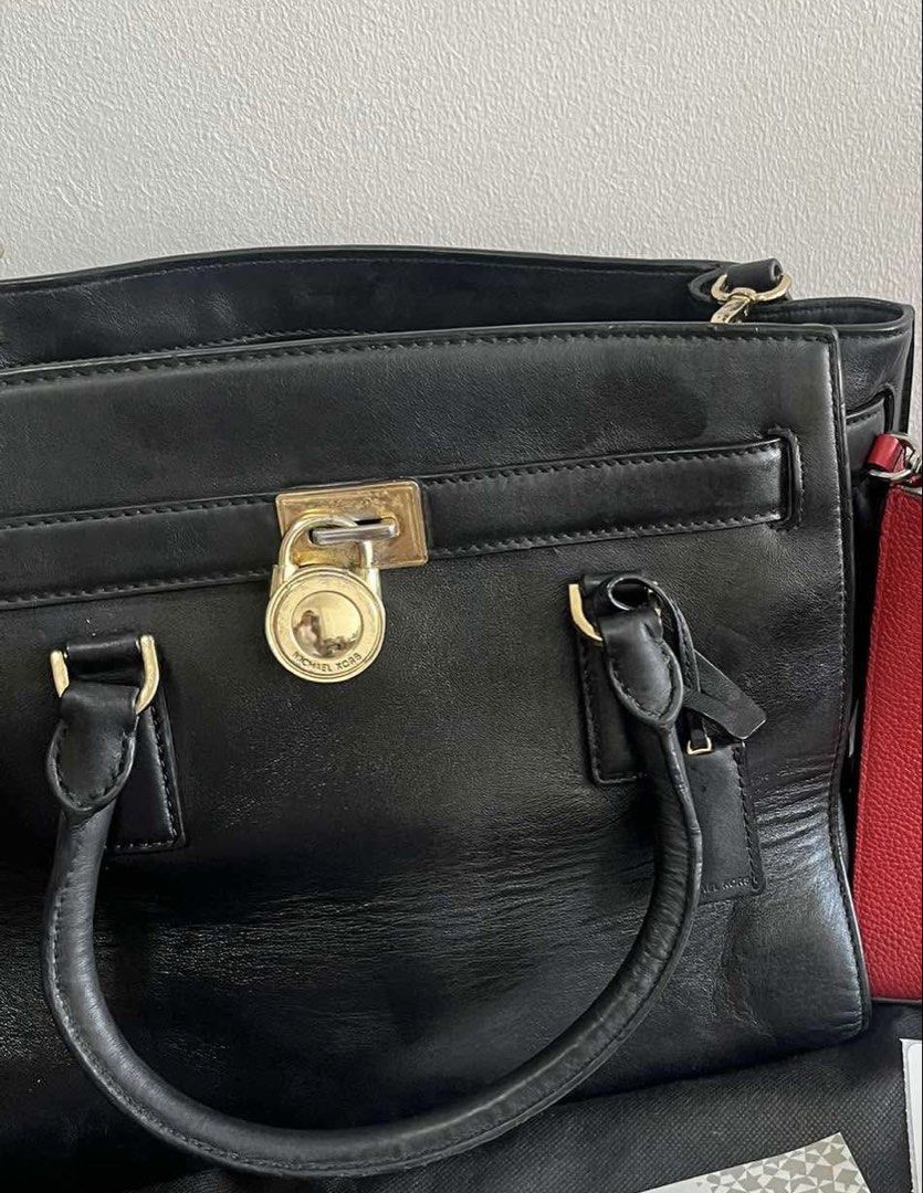 Michael Kors Hamilton Satchel Bag with Strap (Category: Luxury Bags & Wallets) located in Angono. Submitted by wanderlustfashionista (Listing ID 1464740014, Image 2). Description: 🌸 Guaranteed Authentic Michael Kors Bag 👜Thrifted from a legit Japan curated shop 💓A classic black leather Michael Kors Hamilton satchel bag with strap. Highlighted by its signature gold-tone MK-engraved padlock closure. ✨Honest flaws: Creasing and slouching, Hardwar