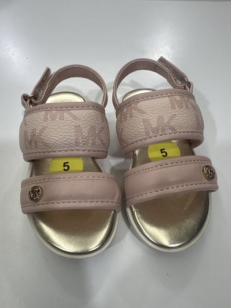 Michael Kors Pink Monogram Sandals Size 5 (Category: Babies & Kids Fashion) located in Angeles City. Submitted by cherryblossom032018 (Listing ID 1464570808, Image 1). Description: - Adorable pink Michael Kors sandals for kids - Features the iconic MK monogram pattern - Stylish gold accents on the straps - Easy and secure velcro closure - Soles display Michael Kors logo and size 5 - Ideal for summer wear.
