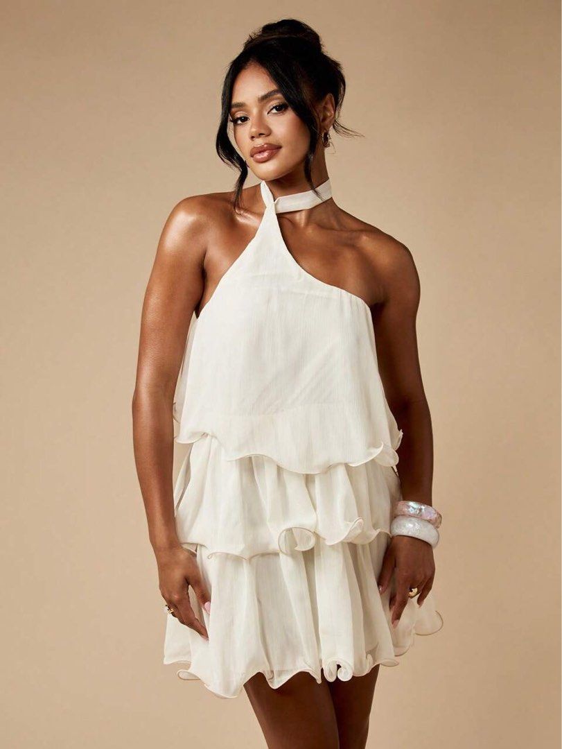 MISSGUIDED One Shoulder Tiered Ruffle Mini Dress (Category: Dresses) located in Tuguegarao City. Submitted by notacoolkid (Listing ID 1464700411, Image 2). Description: - Brand: Missguided - Color: White - Condition: Brand new with tags (never worn) - Design: One-shoulder with halter neck tie and tiered ruffle skirt - Fabric: Lightweight and flowy - Shipping: Ready to ship immediately.