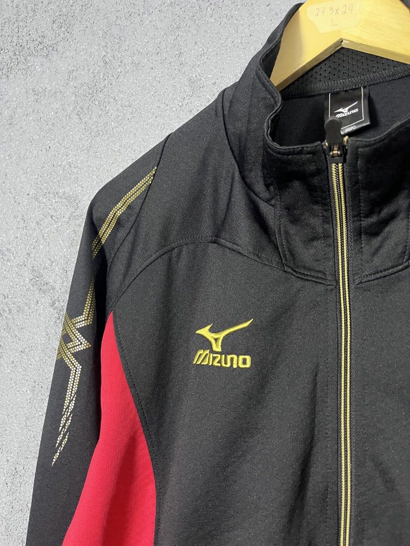 Mizuno Black Red Track Jacket Size L Jaspo (Category: Coats, Jackets and Outerwear) located in Famy. Submitted by basicthrifted (Listing ID 1464702496, Image 3). Description: - Brand: Mizuno - Color: Black and red with gold accents - Size: L Jaspo - Features: Full zip closure, stand collar, and side pockets - Design details: Striking gold graphic detailing on the sleeves and embroidered Mizuno logo on the chest - Condition: Excellent pre-loved co