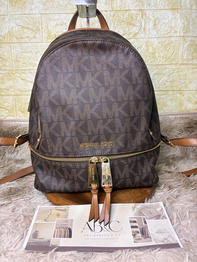 MK Rhea Signature Logo Brown Backpack (Category: Backpacks) located in Subic. Submitted by anabananaco. (Listing ID 1464641296, Image 2). Description: Guaranteed authentic preloved bag from Japan..