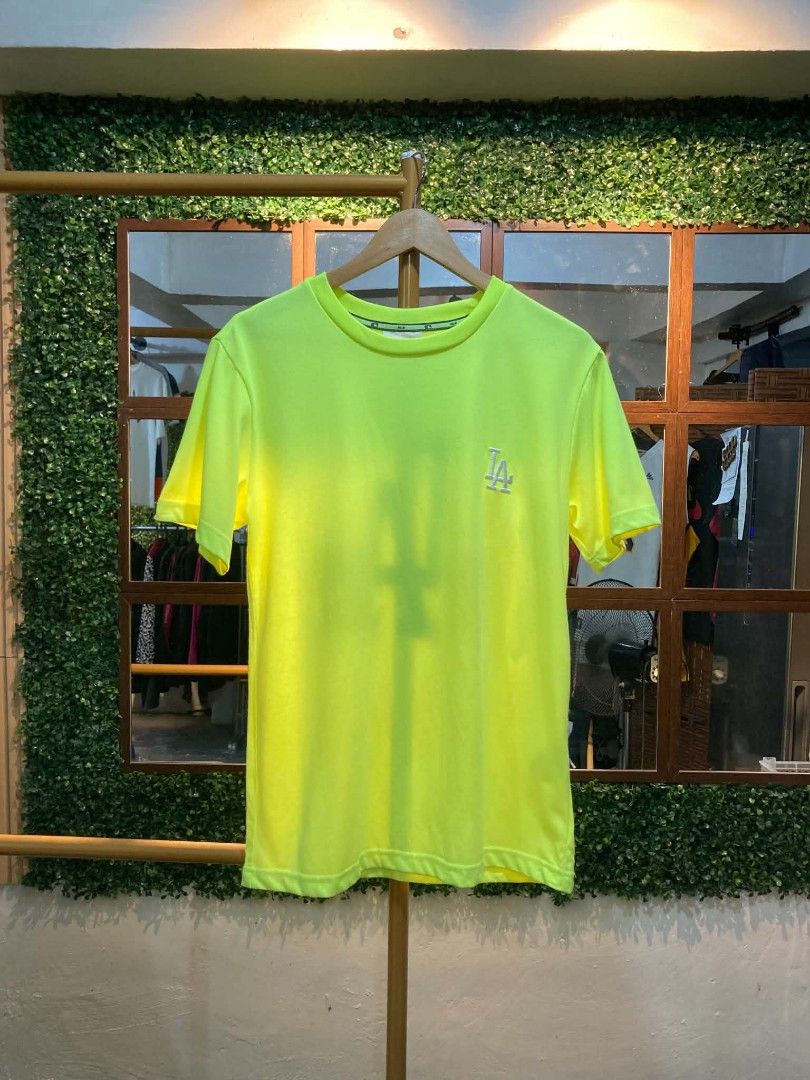 MLB LA Dodgers Neon Yellow T-Shirt (Category: Tshirts & Polo Shirts ) located in Trece Martires City. Submitted by djaothriftshop (Listing ID 1464706032, Image 2). Description: - Authentic MLB Los Angeles Dodgers neon yellow t-shirt - Embroidered team logo on the chest with a large reflective LA graphic on the back - Crew neck design with branded inner taping for added detail - Comfortable cotton and polyester blend fabric.