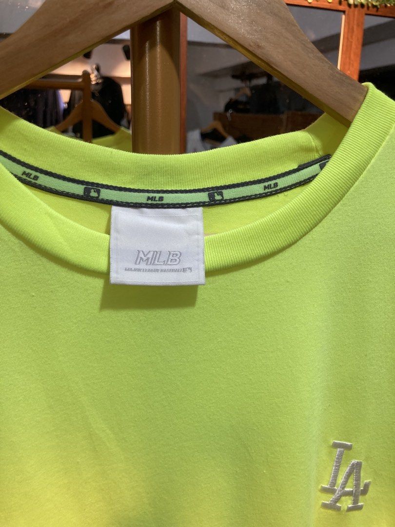 MLB LA Dodgers Neon Yellow T-Shirt (Category: Tshirts & Polo Shirts ) located in Trece Martires City. Submitted by thriftkoto.91 (Listing ID 1464765069, Image 3). Description: - Authentic MLB Los Angeles Dodgers t-shirt in bright neon yellow - Small embroidered LA logo on the front chest - Large reflective graphic logo on the back for extra style - Comfortable cotton blend material for everyday wear - Crew neck featuring printed MLB branding tape