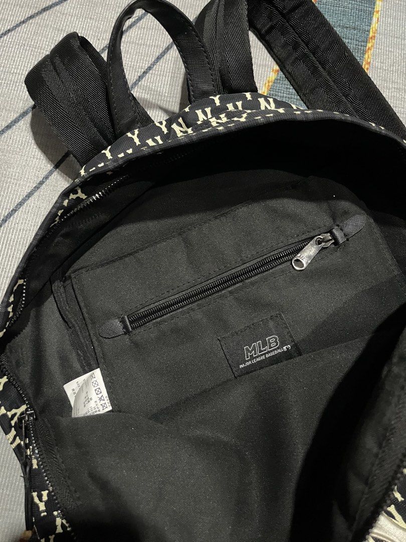 MLB New York Yankees All Over Print Mini Backpack (Category: Backpacks) located in Puerto Princesa. Submitted by dijaydj28 (Listing ID 1464590174, Image 3). Description: - Stylish black and white Yankees mini backpack - Features an all-over NY logo print - Main compartment for essentials - Additional small zippered pocket inside - Adjustable straps for a comfortable fit - Ideal for everyday use or quick outings.