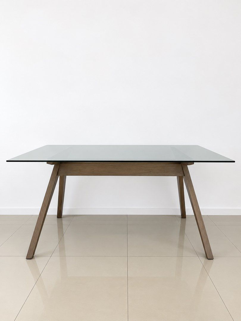 Modern Glass Top Dining Table with Wooden Frame (Category: Tables & Sets) located in San Juan City. Submitted by objectofmyaffection (Listing ID 1464719476, Image 2). Description: 67.25” length /29.5” height/35.5” width - Style: Modern minimalist rectangular dining table - Seating: Comfortably seats up to 6 people - Top: Sleek smoked glass surface - Base: Sturdy dark wood angled legs with a central wooden stretcher - Ideal For: Contemporary dinin