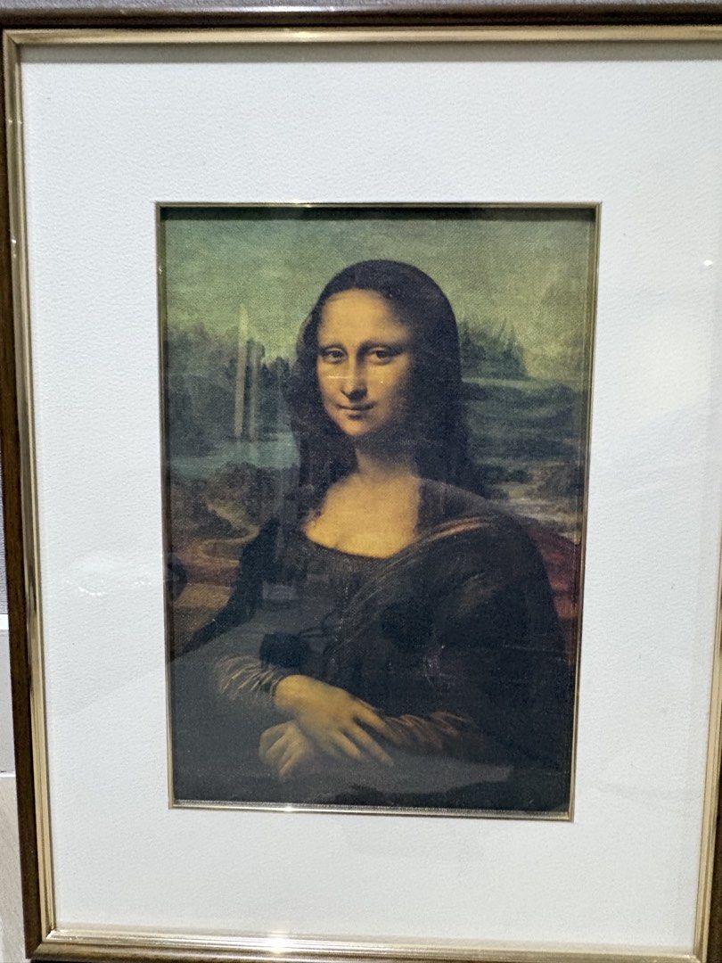 Mona Lisa Framed Print (Category: Art & Prints) located in Manila. Submitted by foundhouseph (Listing ID 1464749454, Image 2). Description: - Classic Mona Lisa print featuring timeless Renaissance art - Size: 30x39cm - Elegant dark wood-finish frame with chic metallic inner trim - Neutral off-white matting for a sophisticated look - Ready to hang with an attached white hanging cord - Clean overall appearance with minimal wear on the hardware and 