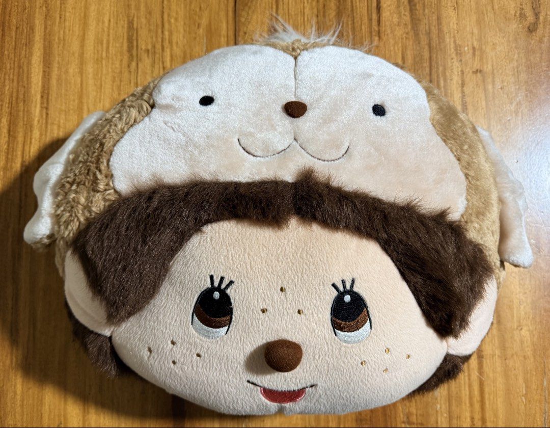 Monchhichi plush pillow soft toy brown white (Category: Plushies & Soft Toys) located in Dasmarinas. Submitted by toyang50 (Listing ID 1464698625, Image 1). Description: - Authentic Monchhichi round plush pillow - Soft furry brown and beige fabric with embroidered facial details - Fluffy texture, perfect for cuddling or aesthetic room decor - Excellent, clean condition with tag still attached - No stains, flaws, or tears.