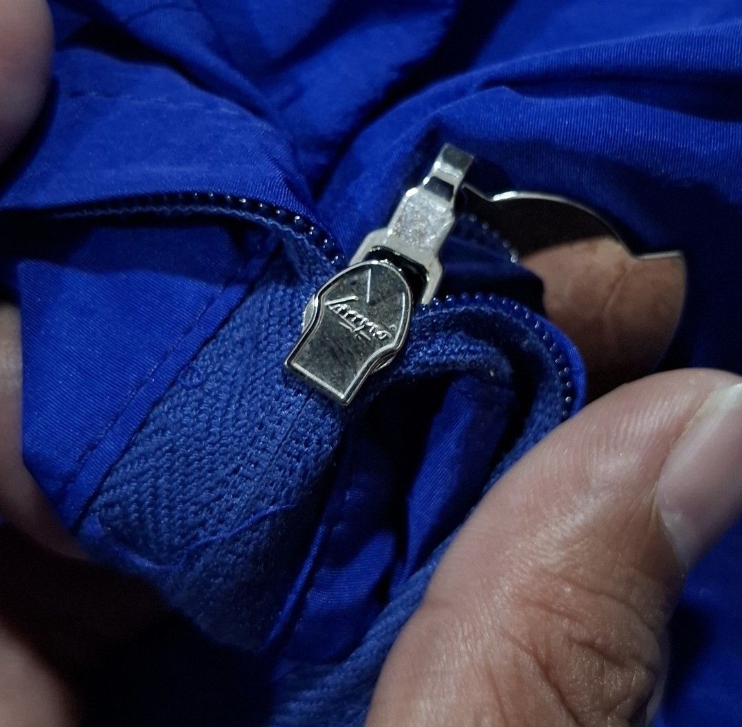 Moncler Blue Windbreaker Jacket (Category: Coats, Jackets and Outerwear) located in Sorsogon. Submitted by johnmichae69459 (Listing ID 1464641413, Image 3). Description: - Authentic Moncler windbreaker jacket in blue. - Lightweight and perfect for layering or standalone wear. - Features the iconic Moncler logo prominently on the chest. - Convenient front pockets for essentials. - Secure fit with elasticated cuffs and hem. - Distinctive Moncler lo