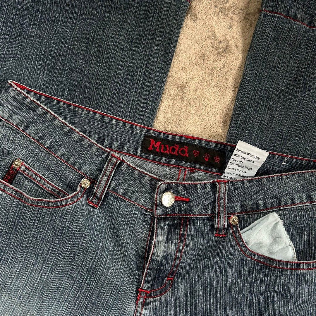 Mudd Flare Vntg y2k Jeans with Red Stitching (Category: Jeans) located in Davao. Submitted by read_my_abouts (Listing ID 1464590521, Image 2). Description: - Classic Mudd jeans waist: 28-30 inches length:41 inches laid flat - Flare leg style - Red contrast stitching throughout - Raw, distressed hem edge - Ideal for Y2K and retro outfits - Versatile for dressing up or down.