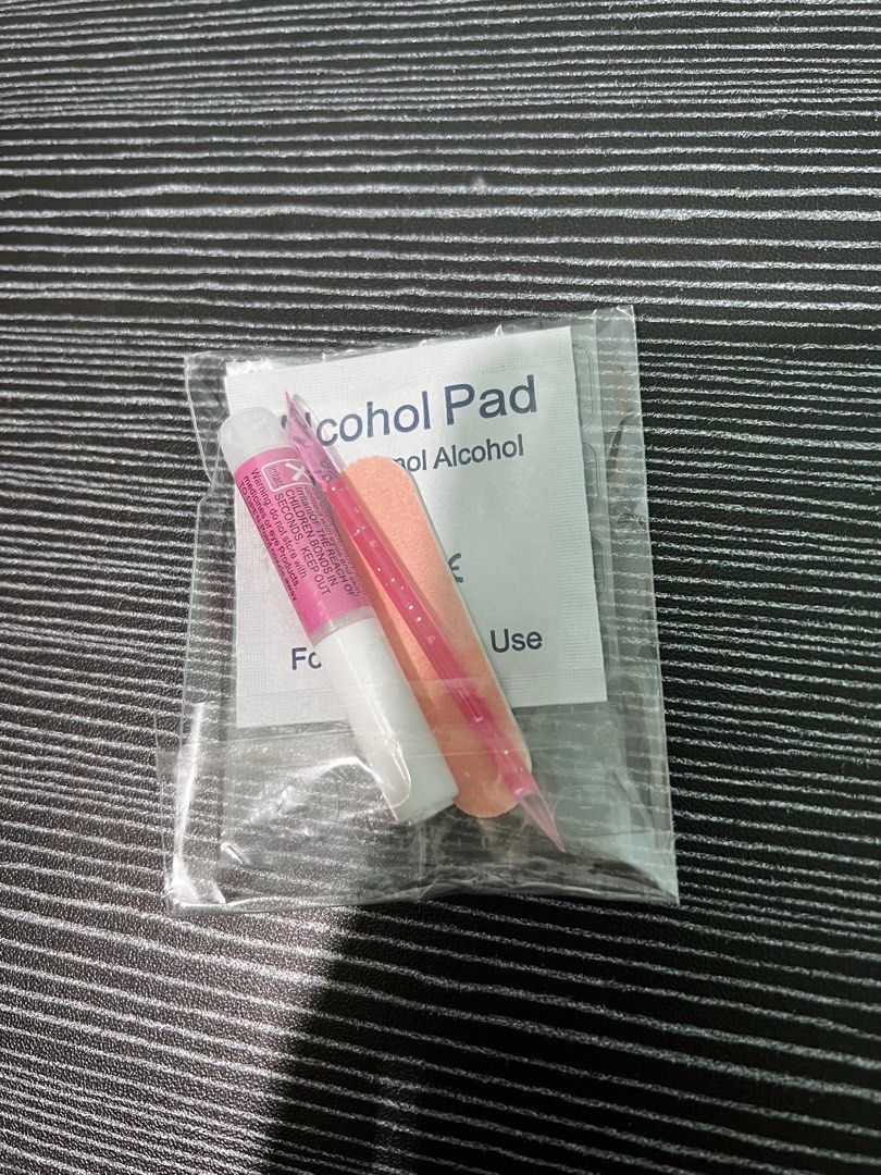 Nail glue alcohol pad mini file cuticle pusher set (Category: Hands & Nails) located in Consolacion. Submitted by hann_m_m (Listing ID 1464760913, Image 1). Description: - Complete mini prep kit for press-on nails - Includes strong nail glue for secure wear - Mini orange nail file for shaping and buffing - Pink cuticle pusher stick for nail prep - Alcohol pad for cleaning and sanitizing - Conveniently sealed in a clear plastic baggie.