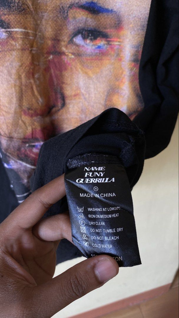 Namefunnyguerilla Rap Tee (Category: Tshirts & Polo Shirts ) located in Tacurong. Submitted by styledtwice1999 (Listing ID 1464605168, Image 2). Description: 🔥NameFunnyGuerilla Rap tee Color rate : 9 Print condition : 💎💎💎 issue: Small pinhole on Neck tag. ( see the last picture fellas ♥️.