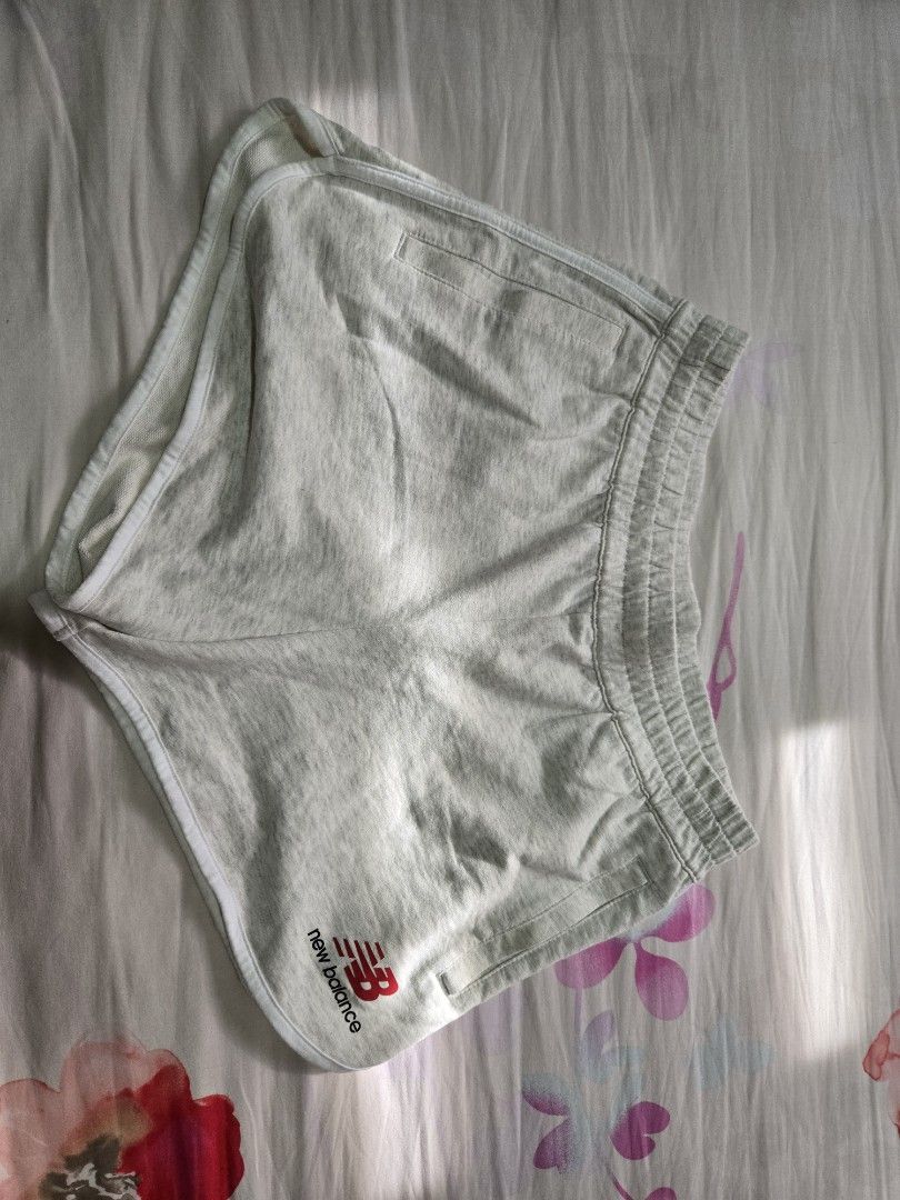 New Balance Grey Athletic Shorts (Category: Shorts) located in Quezon City. Submitted by mgdeclutters (Listing ID 1464600354, Image 1). Description: - Grey New Balance athletic shorts - Elastic waistband with drawstring - Side pockets - Small New Balance logo on left leg - White trim along hem and pockets - Comfortable for lounging or workouts.