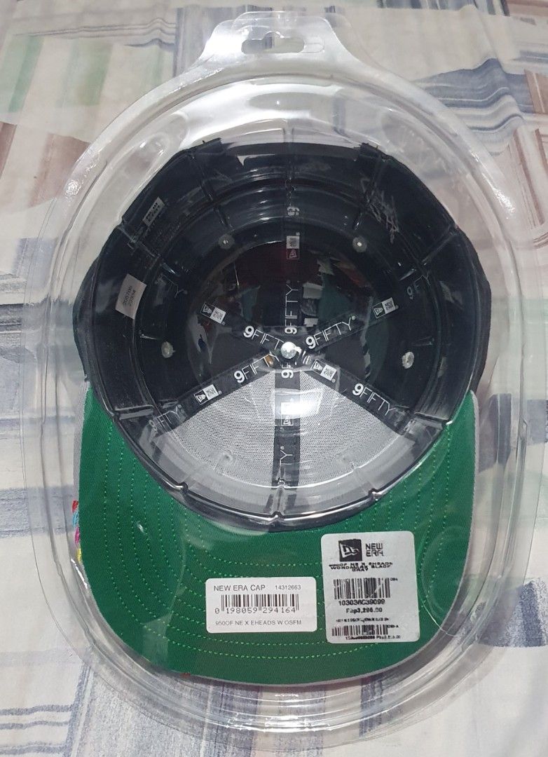 New Era 9FIFTY Snapback Cap 3HEADS Collaboration (Category: Caps & Hats) located in Davao. Submitted by goldenphoenix_6cd296 (Listing ID 1464681706, Image 3). Description: - Brand: New Era - Style: 9FIFTY Snapback Cap - Front Logo: 3HEADS - Back Details: 'EST. 1989' and signature-like embroidery - Brim: Grey with colorful stripe detail - Sizing: One size fits most (adjustable snapback) - Condition: Brand new, still in original packaging.