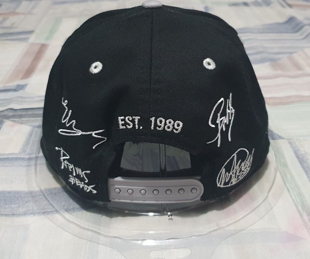 New Era 9FIFTY Snapback Cap 3HEADS Collaboration (Category: Caps & Hats) located in Davao. Submitted by goldenphoenix_6cd296 (Listing ID 1464681706, Image 2). Description: - Brand: New Era - Style: 9FIFTY Snapback Cap - Front Logo: 3HEADS - Back Details: 'EST. 1989' and signature-like embroidery - Brim: Grey with colorful stripe detail - Sizing: One size fits most (adjustable snapback) - Condition: Brand new, still in original packaging.