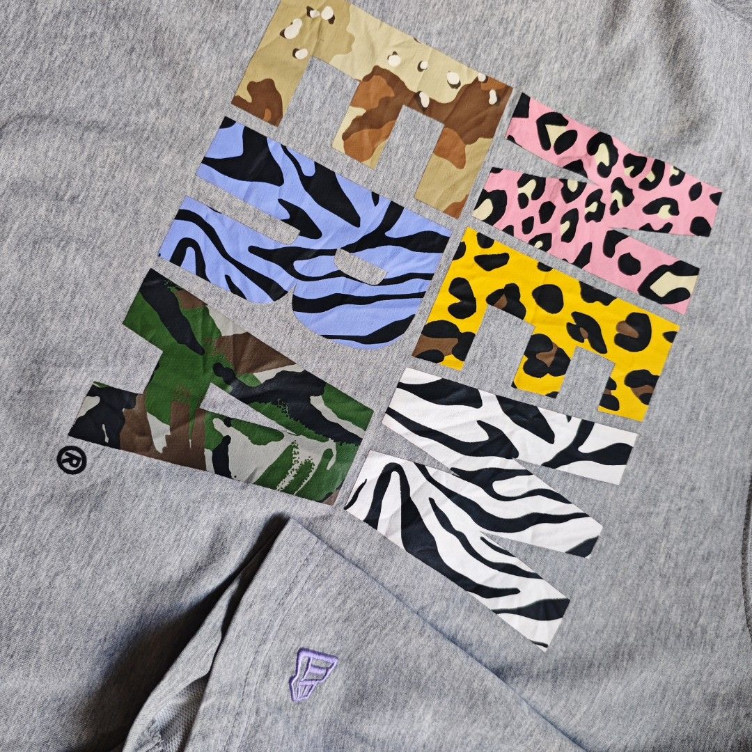 New Era T-Shirt Grey Mix Pattern Logo (Category: Tshirts & Polo Shirts ) located in Ipil. Submitted by ajthriftfinds (Listing ID 1464634681, Image 2). Description: - W: 21.5 - L: 28 - Good condition - Konting scratch sa likod ng neck and small stain need wash - Features a unique animal and camouflage print New Era logo - Tagged as 100(L) - please check measurements for accurate fit - Ideal for casual everyday wear.