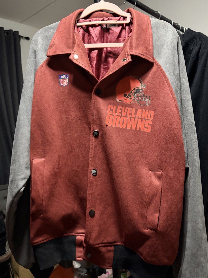 NFL Cleveland Browns Team Apparel Jacket Size L (Category: Coats, Jackets and Outerwear) located in Manila. Submitted by finderskeepersmnl_092026 (Listing ID 1464745103, Image 1). Description: - Brand: NFL Team Apparel (Cleveland Browns) - Size: Large - Color: Deep reddish-brown body with grey sleeves - Design: Classic team helmet graphic and official NFL logo on chest - Features: Snap button-down front, pointed collar, and smooth maroon inner li