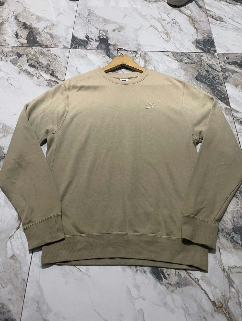 Nike Beige Crewneck Sweatshirt (Category: Coats, Jackets and Outerwear) located in Manila. Submitted by mikeee03 (Listing ID 1464692299, Image 3). Description: - Brand: Nike - Style: Crewneck sweatshirt - Color: Neutral beige / earth tone - Logo: Classic embroidered Nike swoosh on left chest - Comfort: Soft fleece interior, ribbed collar, cuffs, and hem - Fit: Standard fit, perfect for layering - Condition: Brand new / Excellent quality - Perfect