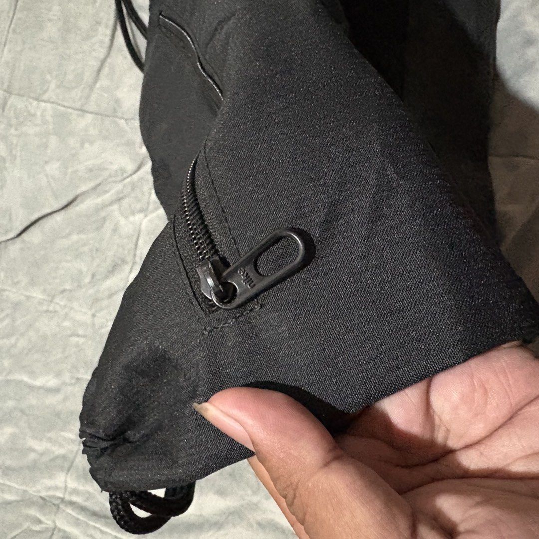 Nike Black Drawstring Gym Bag (Category: Backpacks) located in Carmen. Submitted by rr_thrifts (Listing ID 1464723069, Image 3). Description: - Brand: Nike - Color: Classic Black with Large White Swoosh - Material: 100% Polyester (Body and Lining) - Features: Handy vertical zip pocket on the side for small essentials - Closure: Smooth and durable drawstring - Condition: Excellent, lightweight and simple to use .