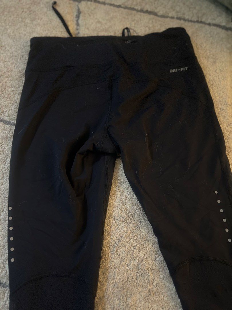 Nike Dri-Fit Black Running Capris Size M (Category: Activewear) located in Quezon. Submitted by lovdogs (Listing ID 1464622083, Image 3). Description: - Black Nike Dri-Fit running capris - Size: Medium - Features reflective dots on lower legs for enhanced visibility - Adjustable drawstring waist for a secure fit - Ideal for running, workouts, and active wear - Made in Cambodia.