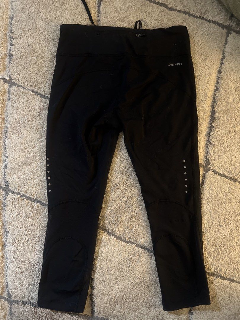 Nike Dri-Fit Black Running Capris Size M (Category: Activewear) located in Quezon. Submitted by lovdogs (Listing ID 1464622083, Image 2). Description: - Black Nike Dri-Fit running capris - Size: Medium - Features reflective dots on lower legs for enhanced visibility - Adjustable drawstring waist for a secure fit - Ideal for running, workouts, and active wear - Made in Cambodia.
