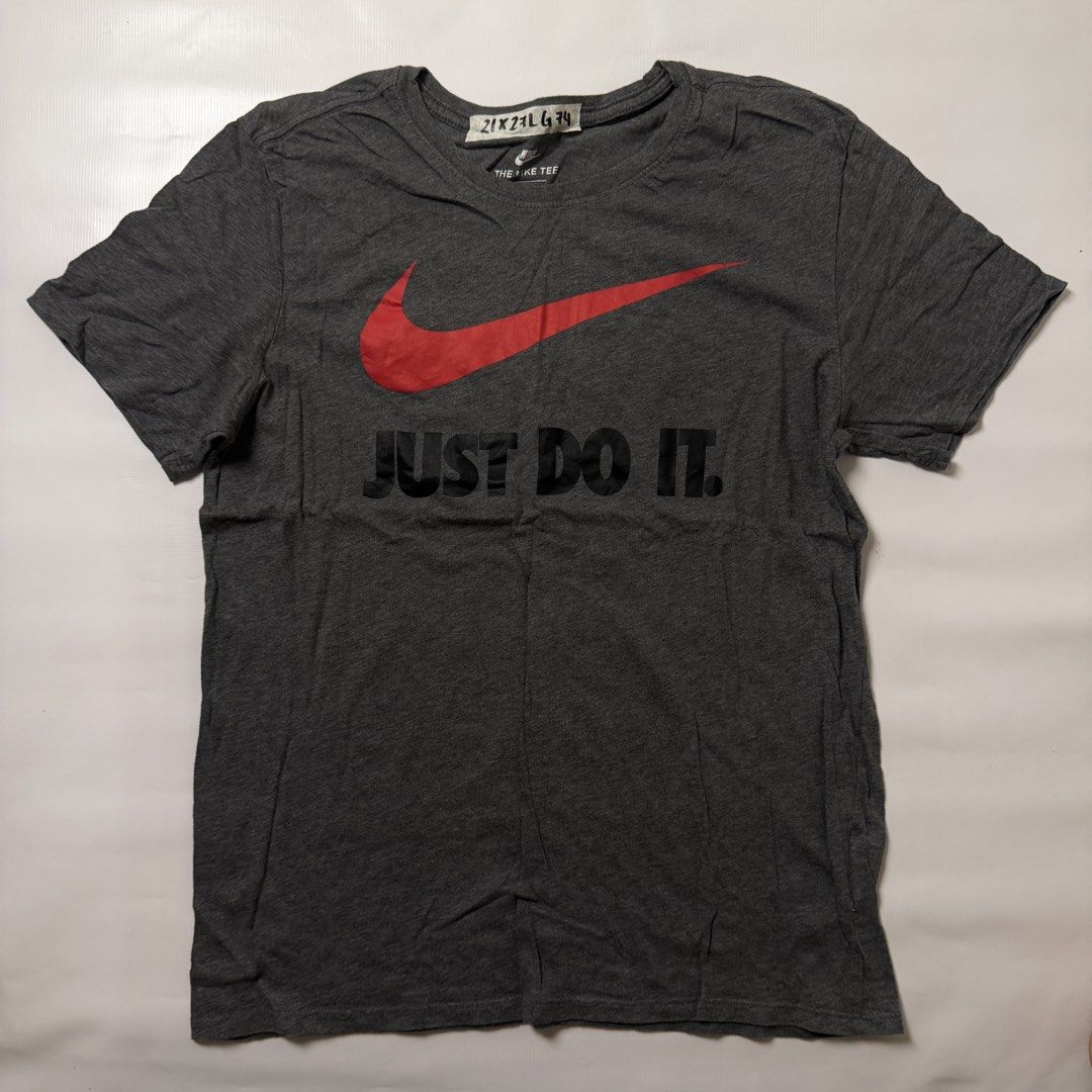 Nike Just Do It Grey T-Shirt Size L (Category: Tshirts & Polo Shirts ) located in Manila. Submitted by johnedel_james (Listing ID 1464697985, Image 1). Description: - Brand: Nike (The Nike Tee) - Size: Large - Color: Grey with red swoosh and black 'Just Do It' chest graphic - Material: 100% Cotton - Origin: Made in Egypt - Fit: Athletic cut - Condition: Excellent pre-loved condition (tagged inside collar).