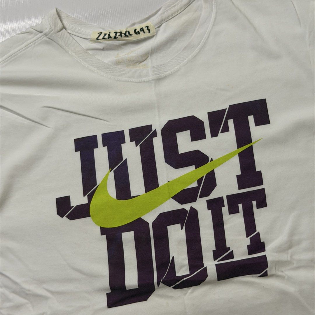 Nike Just Do It White T-Shirt (Category: Tshirts & Polo Shirts ) located in Manila. Submitted by johnedel_james (Listing ID 1464708184, Image 2). Description: - Brand: Nike - Color: White with purple & lime green 'Just Do It' graphic - Material: 60% cotton, 40% polyester - Fit: Standard fit - Details: Short sleeves, crew neck, made in Jordan - Condition: Clean, casual, and perfect for daily wear.