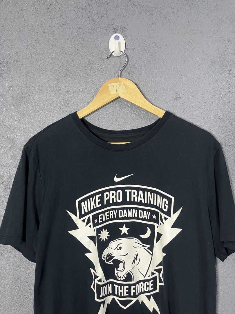 Nike Pro Training Join The Force T-Shirt Black Large (Category: Activewear) located in Famy. Submitted by basicthrifted (Listing ID 1464704555, Image 2). Description: - Brand: Nike Pro - Size: Large (Athletic cut) - Color: Black - Material: Dri-Fit technology fabric for sweat-wicking comfort - Design: Bold front panther graphic with 'Every Damn Day' and 'Join The Force' lettering - Condition: Good, with inner collar tag and lower care tags attach