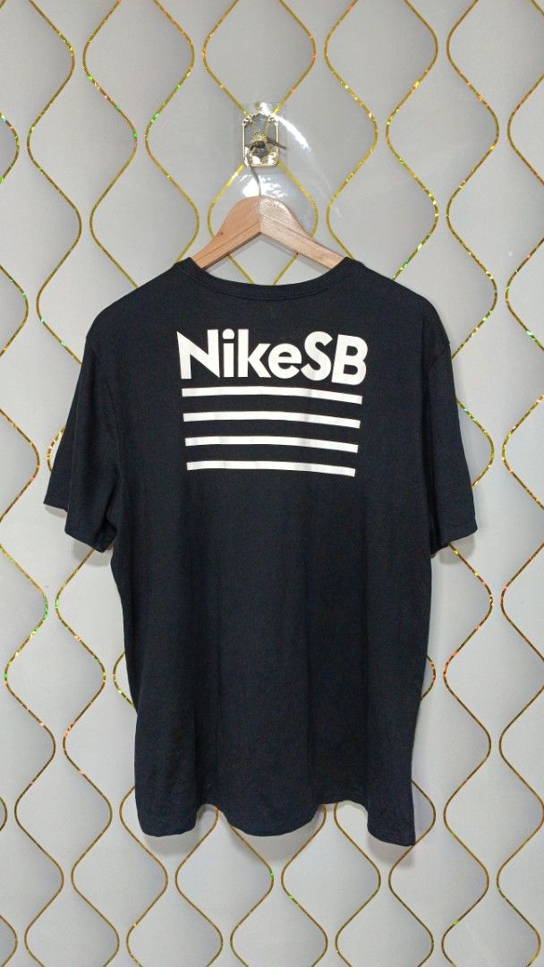Nike SB The Nike Tee Black Graphic (Category: Tshirts & Polo Shirts ) located in Manila. Submitted by zariyah.1986 (Listing ID 1464756168, Image 3). Description: - Brand: Nike SB (The Nike Tee line) - Color: Black with white graphics - Material: Dri-FIT (moisture-wicking, athletic wear) - Size: XXL (Athletic cut fit) - Measurements: 23 inches across chest, 27 inches length - Design: Small front chest logo and large back graphic with horizontal li