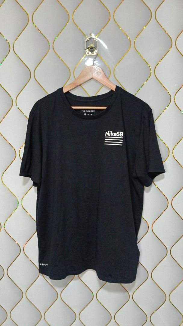 Nike SB The Nike Tee Black Graphic (Category: Tshirts & Polo Shirts ) located in Manila. Submitted by zariyah.1986 (Listing ID 1464756168, Image 1). Description: - Brand: Nike SB (The Nike Tee line) - Color: Black with white graphics - Material: Dri-FIT (moisture-wicking, athletic wear) - Size: XXL (Athletic cut fit) - Measurements: 23 inches across chest, 27 inches length - Design: Small front chest logo and large back graphic with horizontal li