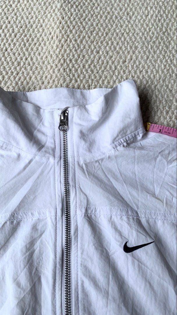 Nike Sportswear Everything Jacket Asia Sizing White (Category: Coats, Jackets and Outerwear) located in Jamindan. Submitted by darinville30528 (Listing ID 1464609337, Image 3). Description: - White Nike Jacket - Asia Sizing - Full Zip Closure - Elasticated Cuffs and Hem - Small Nike Swoosh Logo on Chest - Ideal for Everyday Wear or Light Workouts.
