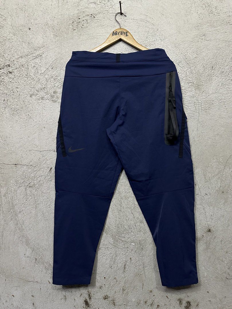 Nike Tech Fleece Cargo Pants Navy Blue (Category: Joggers) located in Quezon City. Submitted by stre3tw3ar (Listing ID 1464584403, Image 2). Description: - Navy blue Nike Tech Fleece cargo pants - Multiple pockets for storage - Convenient side zipper pocket - Adjustable drawstring waist - Ideal for everyday wear or training - Medium On tag - 32 On tape - 37 Length - 6 Hem.