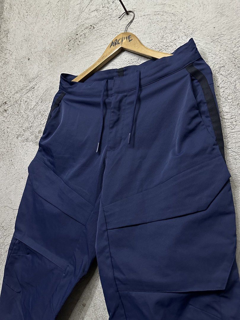 Nike Tech Fleece Cargo Pants Navy Blue (Category: Joggers) located in Quezon City. Submitted by stre3tw3ar (Listing ID 1464584403, Image 3). Description: - Navy blue Nike Tech Fleece cargo pants - Multiple pockets for storage - Convenient side zipper pocket - Adjustable drawstring waist - Ideal for everyday wear or training - Medium On tag - 32 On tape - 37 Length - 6 Hem.