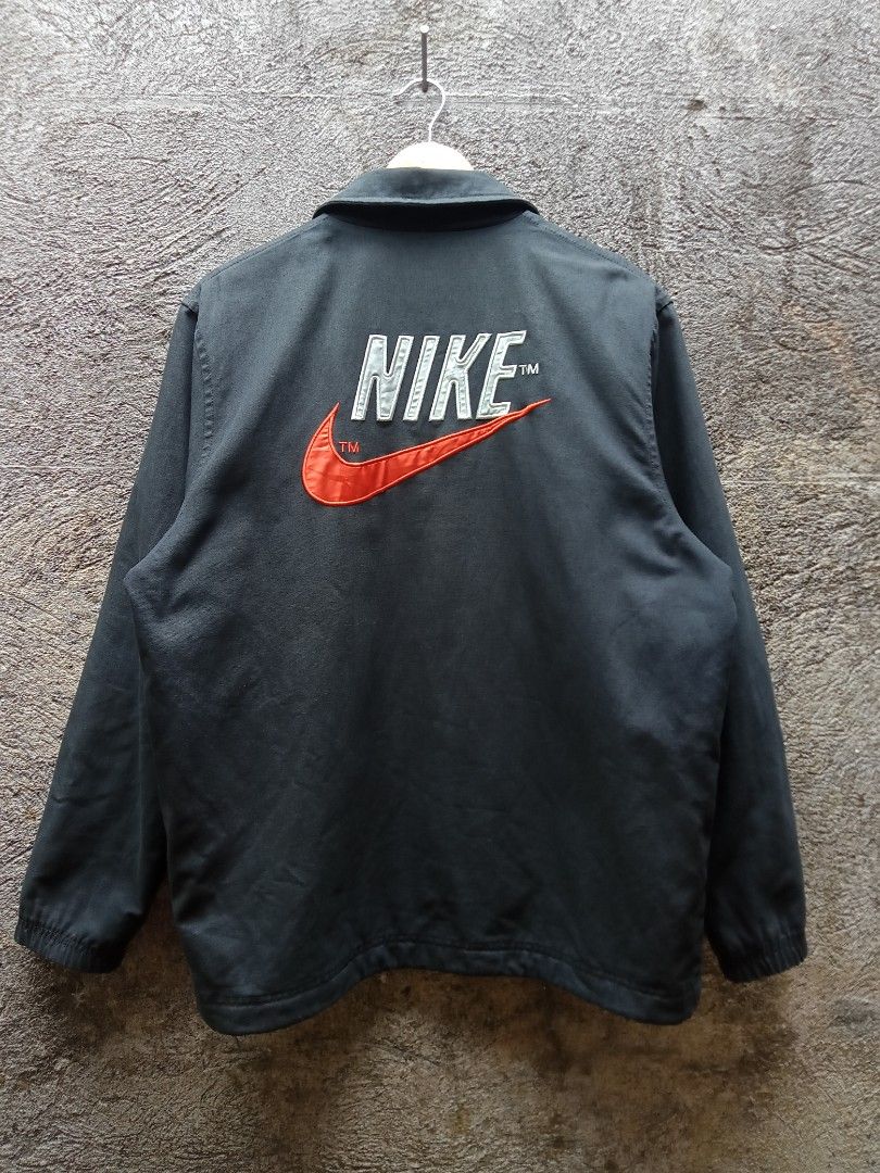 Nike Therma-Fit Coach Jacket (Category: Coats, Jackets and Outerwear) located in Sipocot. Submitted by danthrift122218 (Listing ID 1464622850, Image 3). Description: - Black Nike coach jacket - Features Therma-Fit technology for warmth - Large embroidered Nike swoosh on back - Smaller embroidered swoosh on chest - Quilted lining for extra insulation - Snap button closure - Ideal for cooler weather.