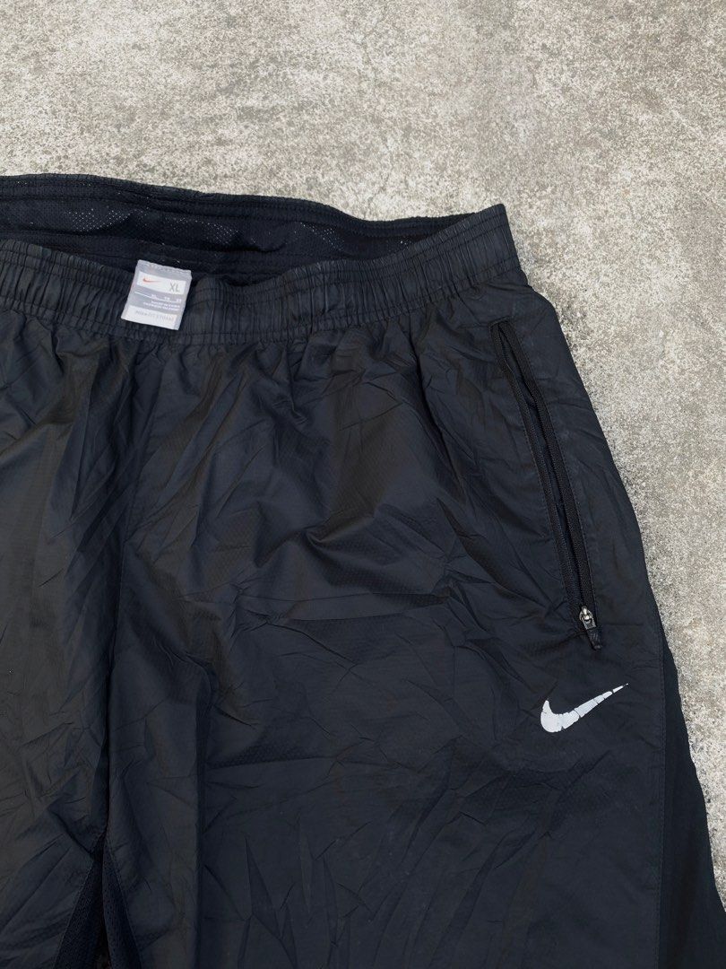 Nike Track Pants (Category: Joggers) located in Iba. Submitted by gotmethrift (Listing ID 1464583719, Image 2). Description: - Black Nike track pants - Size XL - Zippered side pockets - Elastic waistband with drawstring - Nike Fit Storm material - Ideal for workouts or casual wear - Made in China.