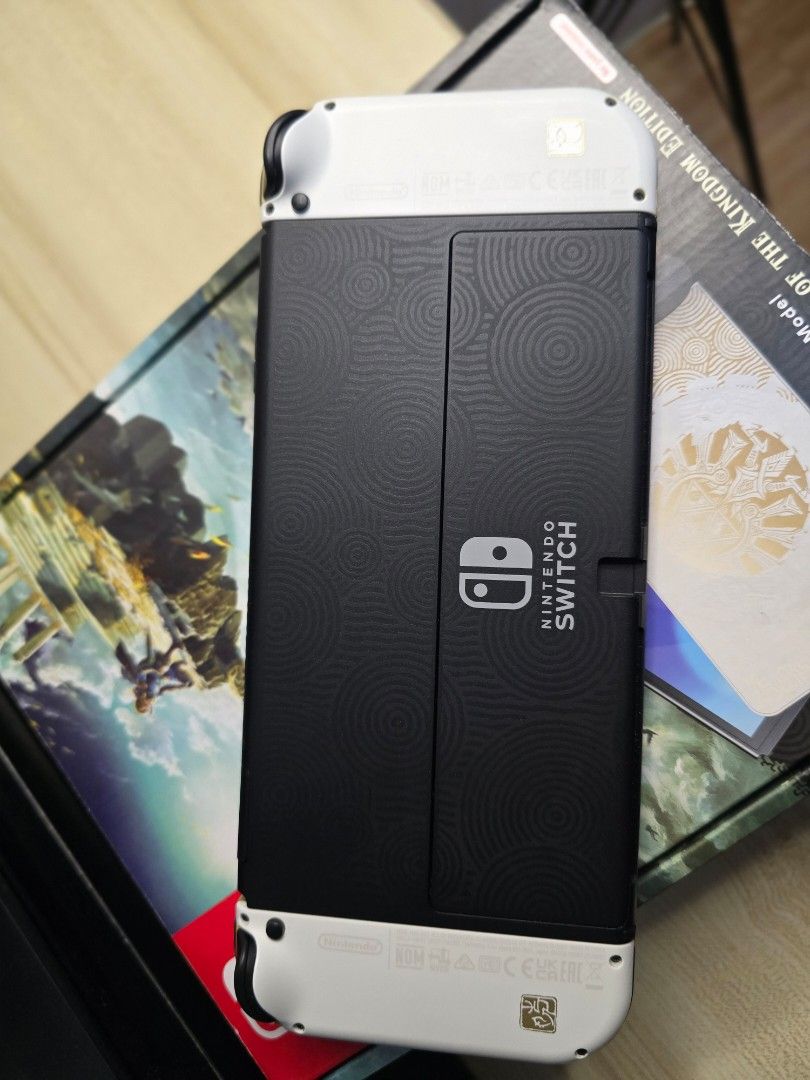 Nintendo Switch OLED - Zelda TOTK Edition (Category: Nintendo) located in Cebu City. Submitted by _ctrl (Listing ID 1464736939, Image 3). Description: FS Nintendo Switch OLED - Zelda TOTK Edition Good condition Complete set with box Inclusions: - Original charger - dock - hdmi - joycon grip - joycon straps - Mobapad S1 HD Controller - Switch Grip Case - 4 Controller Charging Dock Station Physical game: Zelda Breath of the wild (cartridge only, no