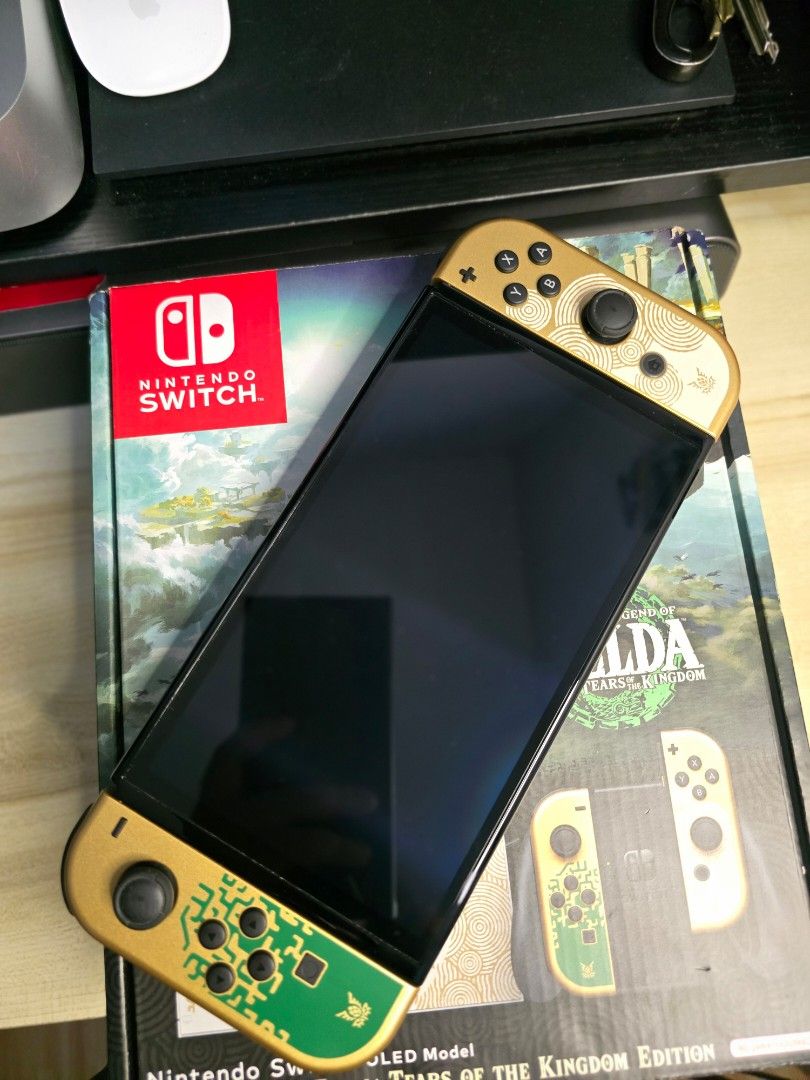 Nintendo Switch OLED - Zelda TOTK Edition (Category: Nintendo) located in Cebu City. Submitted by _ctrl (Listing ID 1464736939, Image 2). Description: FS Nintendo Switch OLED - Zelda TOTK Edition Good condition Complete set with box Inclusions: - Original charger - dock - hdmi - joycon grip - joycon straps - Mobapad S1 HD Controller - Switch Grip Case - 4 Controller Charging Dock Station Physical game: Zelda Breath of the wild (cartridge only, no