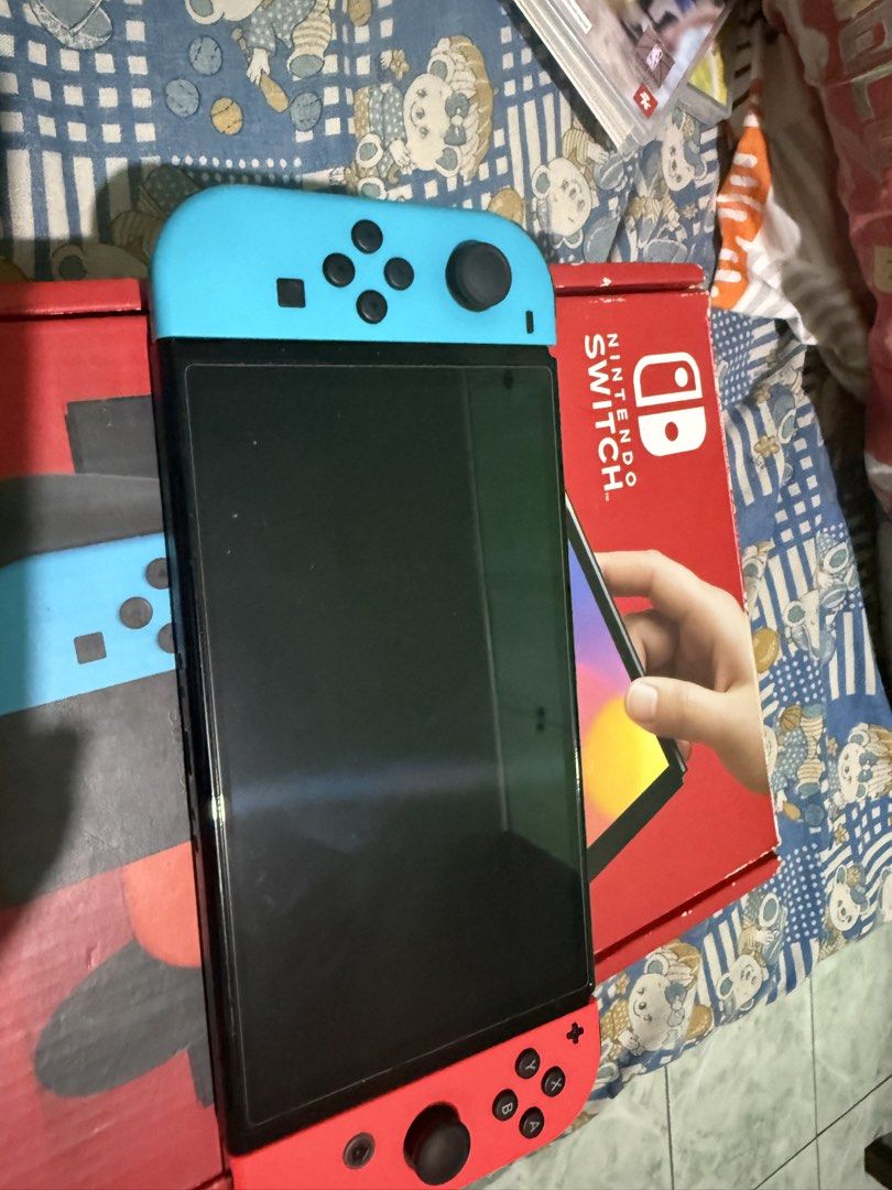 Nintendo Switch OLED Model Console with Neon Red/Blue Joy-Cons (Category: Nintendo) located in Manila. Submitted by jrroque (Listing ID 1464674626, Image 1). Description: - Nintendo Switch OLED Model - Neon Red and Blue Joy-Cons included - Comes with dock and all necessary cables - Original box included - Ready for gaming at home or on the go - Feel free to ask any questions! - comes with two games nba and super mario deluxe - comes with 128 gb m