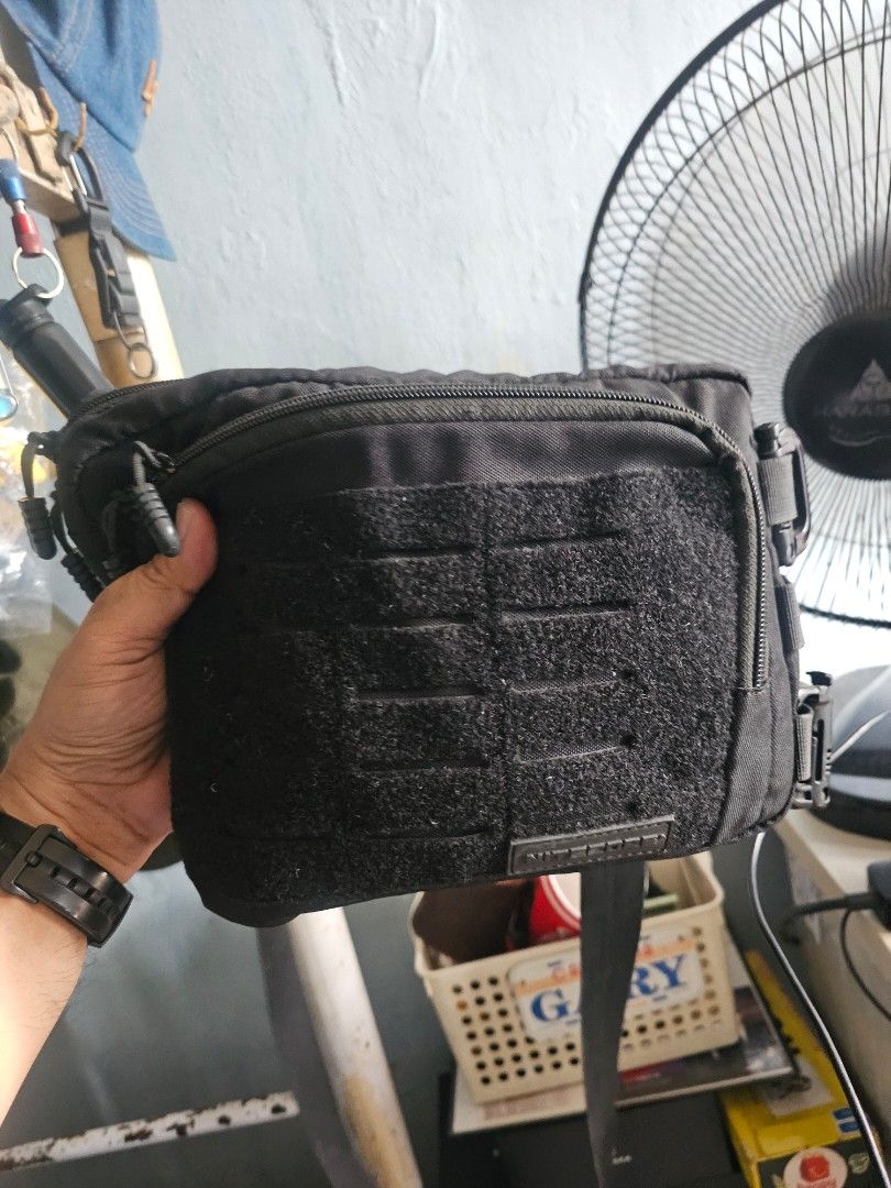 Nitecore Black Tactical Pouch Bag with MOLLE System (Category: Belt bags, Clutches and Pouches) located in Manila. Submitted by cosmicmountain_f0efc.owl (Listing ID 1464603029, Image 1). Description: - Black Nitecore pouch bag - Main compartment with hook-and-loop interior for modular expansions - Auxiliary compartment with key clasp and mesh pocket - Front hook-and-loop area for patches or accessories - MOLLE system on the side for attaching to 