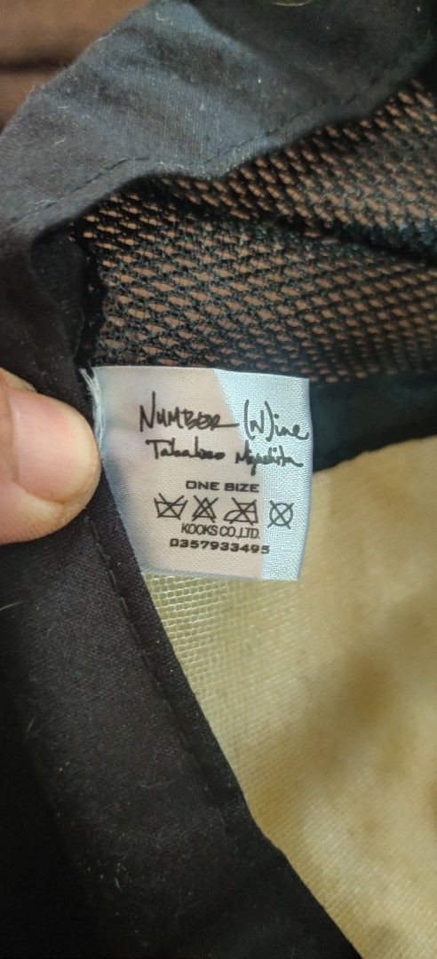 Number (N)ine x Kooks Co. Ltd. Trucker Cap (Category: Caps & Hats) located in Bago City. Submitted by louielinco (Listing ID 1464583338, Image 2). Description: - Collaboration trucker cap by Number (N)ine and Kooks Co. Ltd. - Iconic Number (N)ine logo prominently displayed on the front. - Breathable mesh back for comfort. - Adjustable strap for a one-size-fits-most design. - Ideal for adding a stylish touch to casual outfits..