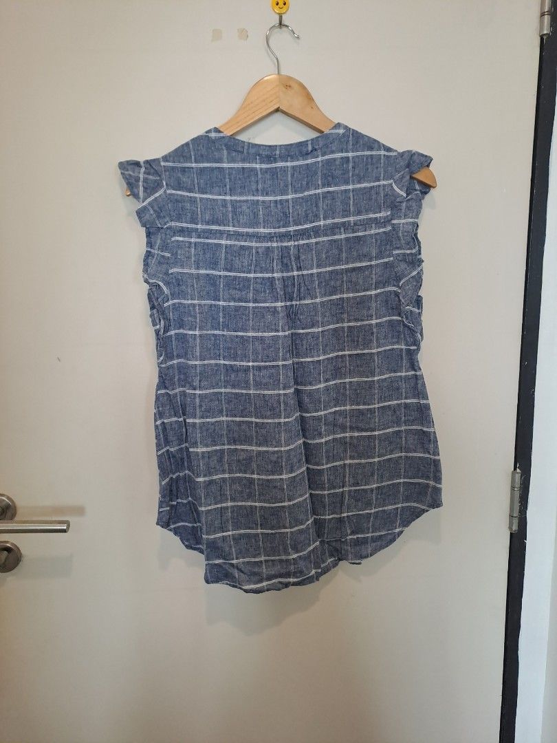 Old navy sleeveless (Category: Sleeveless) located in Manila. Submitted by joanbalde39643 (Listing ID 1464665834, Image 3). Description: This item is an Old Navy Sleeveless Ruffle-Trim Plaid Top, featuring a blue and white windowpane grid pattern, a button-down V-neckline, and flutter/ruffle cap sleeves. It is typically made from a lightweight linen-blend fabric..