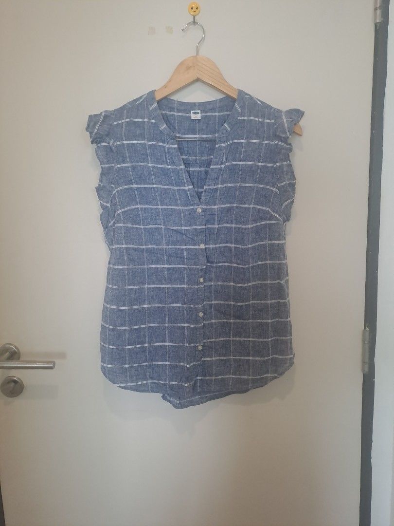 Old navy sleeveless (Category: Sleeveless) located in Manila. Submitted by joanbalde39643 (Listing ID 1464665834, Image 1). Description: This item is an Old Navy Sleeveless Ruffle-Trim Plaid Top, featuring a blue and white windowpane grid pattern, a button-down V-neckline, and flutter/ruffle cap sleeves. It is typically made from a lightweight linen-blend fabric..
