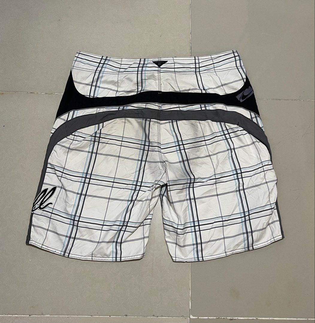 O'Neill Plaid Board Shorts Size 38 (Category: Swim Trunks & Board Shorts) located in Manila. Submitted by micoletszx81430 (Listing ID 1464700527, Image 3). Description: - Brand: O'Neill - Design: White, black, and blue plaid with black side panels and grey piping - Features: Signature O'Neill logo on leg and waistband, secure drawstring closure - Size: 38 (Waist) x 22 (Length) - Condition: Excellent, ready to wear.