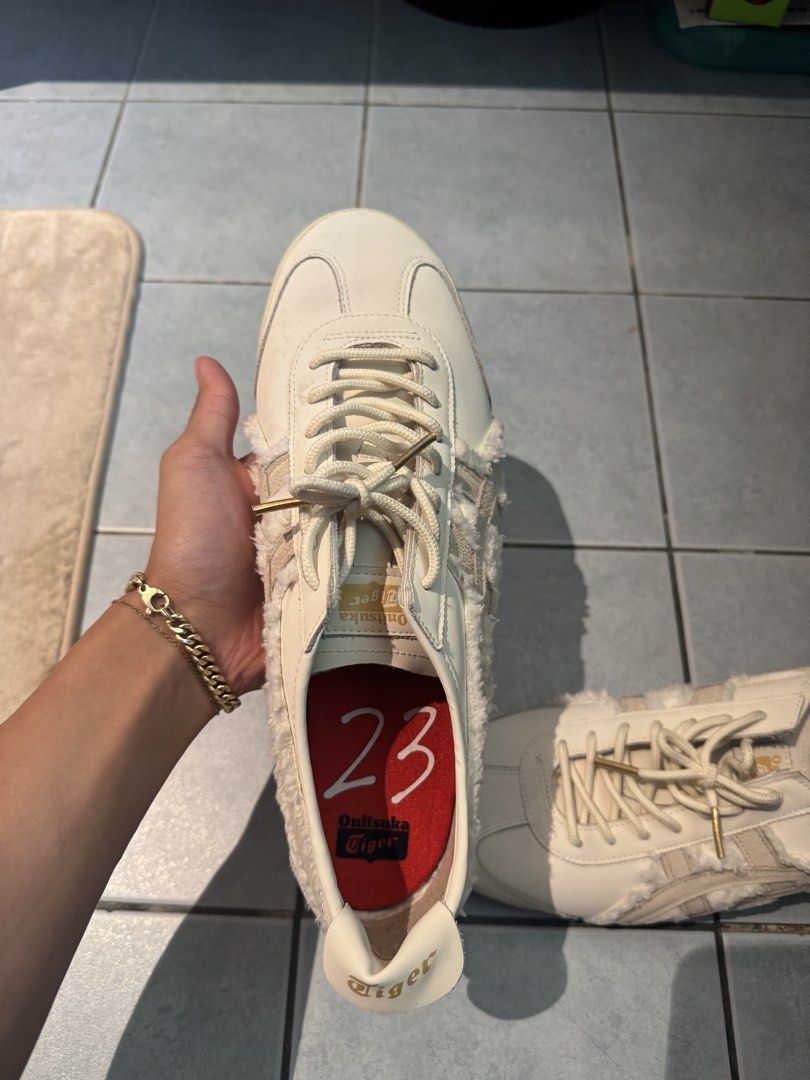 Onitsuka Tiger Mexico 66 (Category: Casual Shoes) located in Muntinlupa City. Submitted by yungbruh66 (Listing ID 1464689489, Image 2). Description: - Brand: Onitsuka Tiger Mexico 66 - Colorway: Cream/Off-White with red insoles (Size 23) - Unique Details: Furry shearling side stripes and heel tab - Premium Accents: Thick rope laces with gold metal aglets, gold foil logo on tongue and heel pull - Condition: Worn a few times, minimal creasing near 