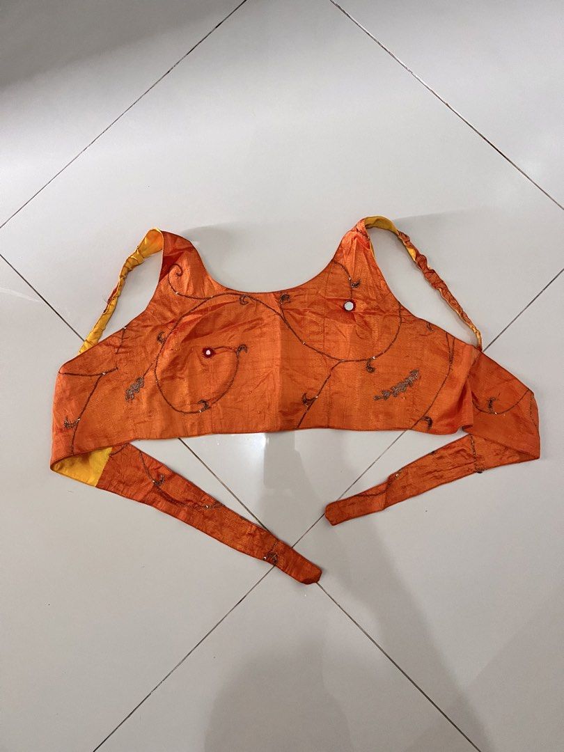 Orange embroidered crop top with mirror work (Category: Blouses) located in Manila. Submitted by coolstorm-3ddc64 (Listing ID 1464661092, Image 1). Description: - Fun & vibrant orange crop top - Yellow lining for a pop of color - Intricate embroidery and small mirror details - Adjustable tie-up straps for a perfect fit - Ideal for festive occasions or stylish casual outfits.