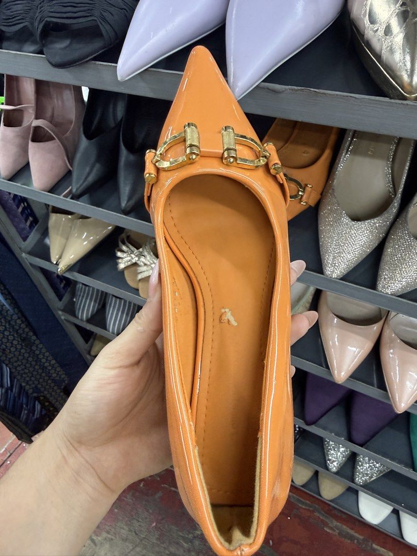 Orange Pointed Toe Heels with Gold Buckle (Category: Heels) located in Manila. Submitted by fastlion.584bdf (Listing ID 1464736960, Image 2). Description: - Color: Vibrant bright orange - Material: Glossy patent finish - Design: Pointy toes with a chic gold buckle front strap - Heel: Comfortable low heel, slip-on style - Condition: Minor wear on the inner sole lining - Style Tip: Great pop of color for standout outfits.
