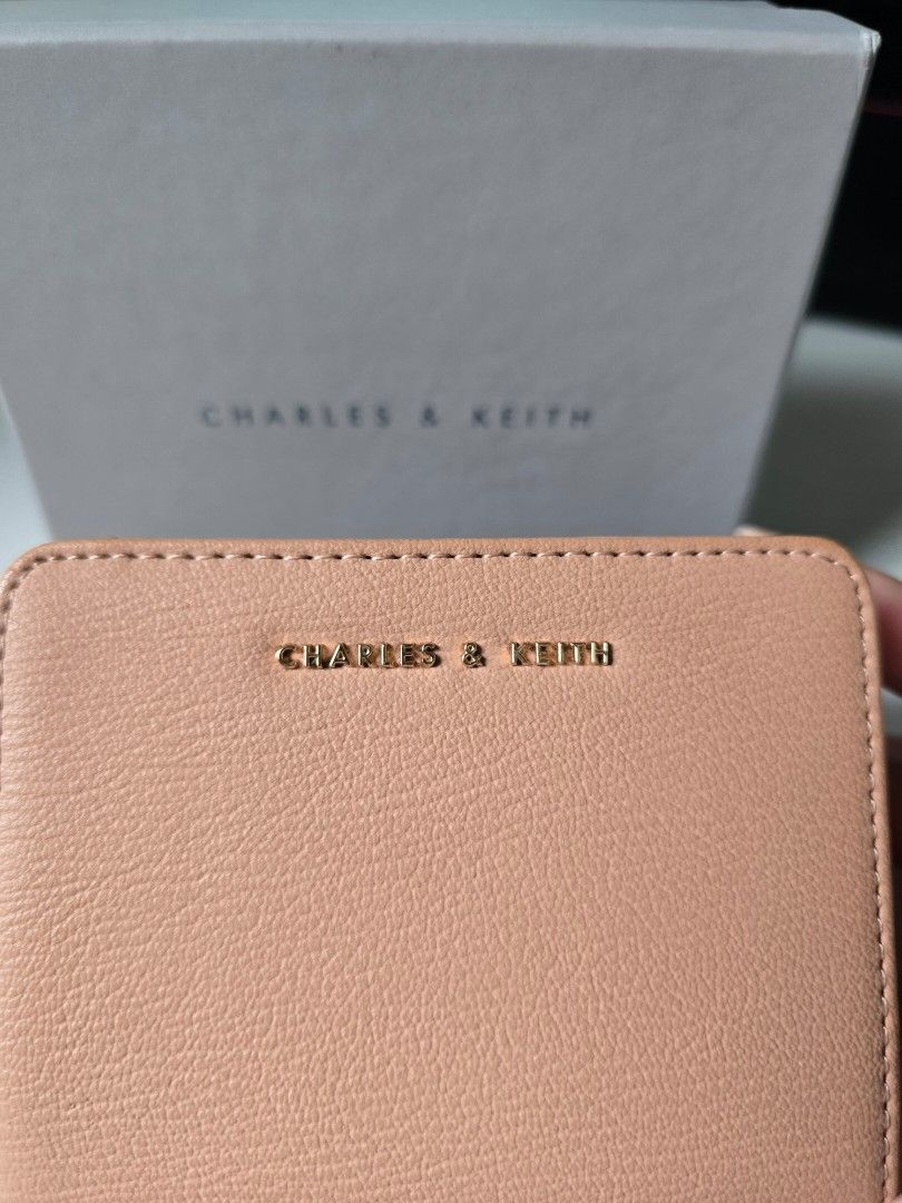 Original Charles & Keith Blush Small Wallet (Category: Wallets & Card holders) located in Taguig. Submitted by ara_shoppe_mnl (Listing ID 1464704581, Image 3). Description: - Brand: Charles & Keith - Style: CK6-10770420-6 - Color: Blush - Size: XXS (Compact design) - Features: Gold-tone hardware and secure zip coin compartment - Condition: Lightly used with mininal flaws due to storage. Please refer to the last photo. - Store bought (C&K High Str