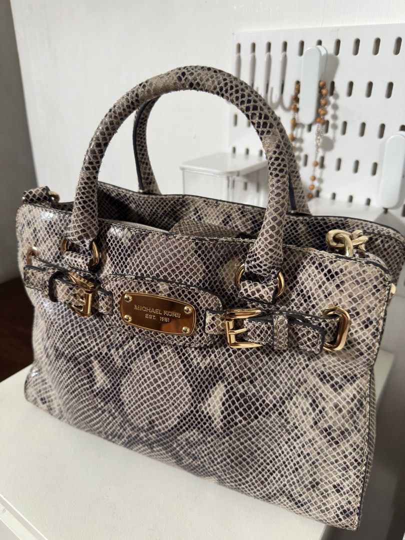 [ORIGINAL] Michael Kors Python Print Leather Satchel Handbag Gold Hardware (Category: Luxury Bags & Wallets) located in Manila. Submitted by r.ivrsn (Listing ID 1464594083, Image 1). Description: - Stylish Michael Kors satchel bag (BOUGHT IN JAPAN) - Eye-catching all-over python print - Elegant gold hardware and buckle details - Comfortable top handles - Includes a detachable shoulder strap for versatility - Spacious interior, ideal for everyday 