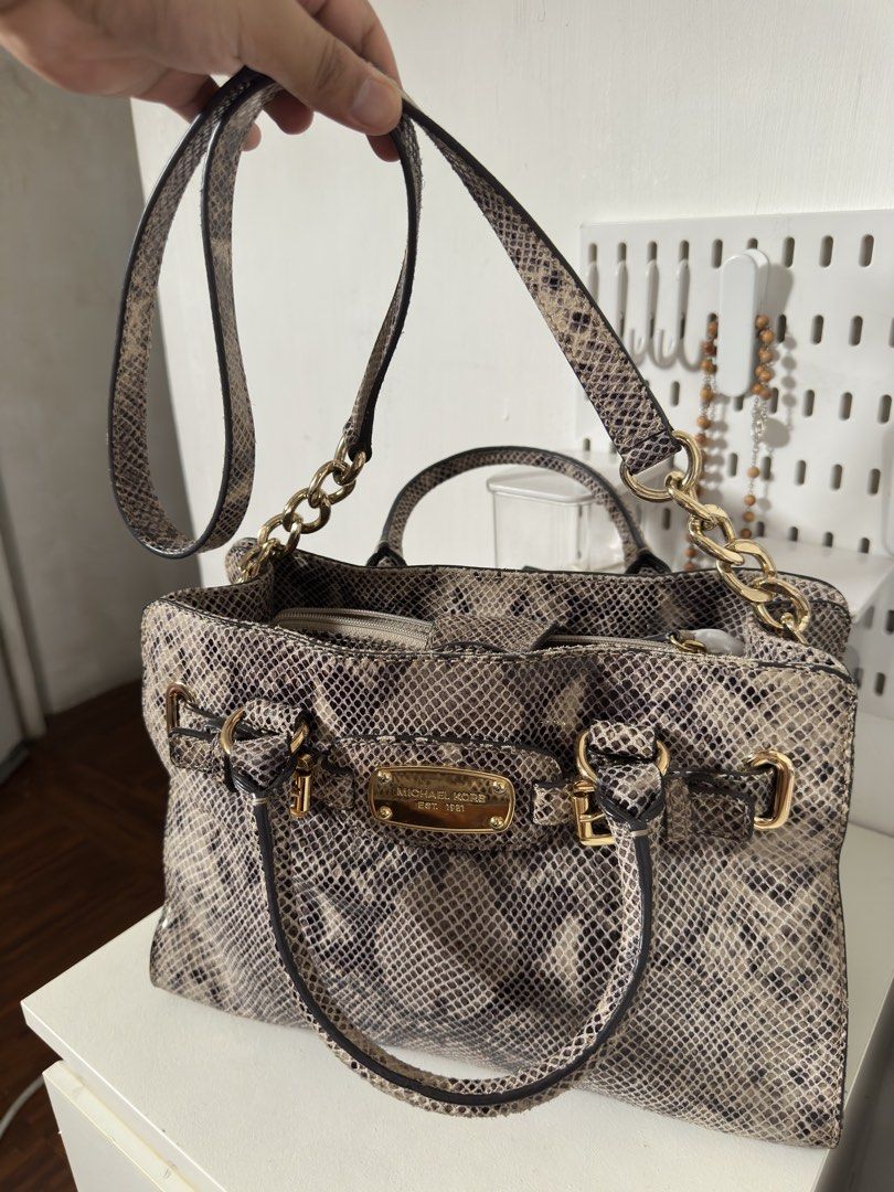 [ORIGINAL] Michael Kors Python Print Leather Satchel Handbag Gold Hardware (Category: Luxury Bags & Wallets) located in Manila. Submitted by r.ivrsn (Listing ID 1464594083, Image 2). Description: - Stylish Michael Kors satchel bag (BOUGHT IN JAPAN) - Eye-catching all-over python print - Elegant gold hardware and buckle details - Comfortable top handles - Includes a detachable shoulder strap for versatility - Spacious interior, ideal for everyday 